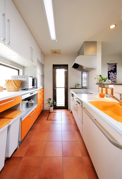 白をベースに、ビタミンカラーのオレンジが鮮やかなキッチン